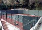Green chain-link tennis court.jpg