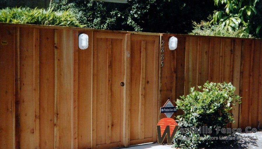 Board and bats redwood fence with 2x4 cap