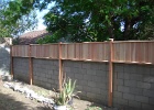 Tongue and gvoove redwood fence on top of wall.JPG